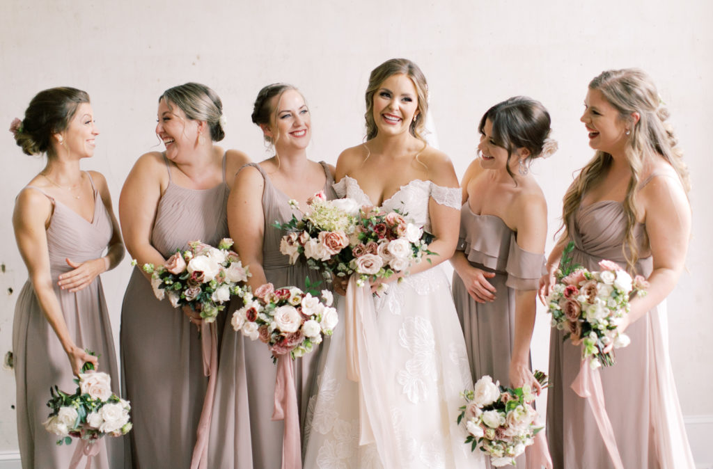 Bride and bridesmaids with floral bouquets 