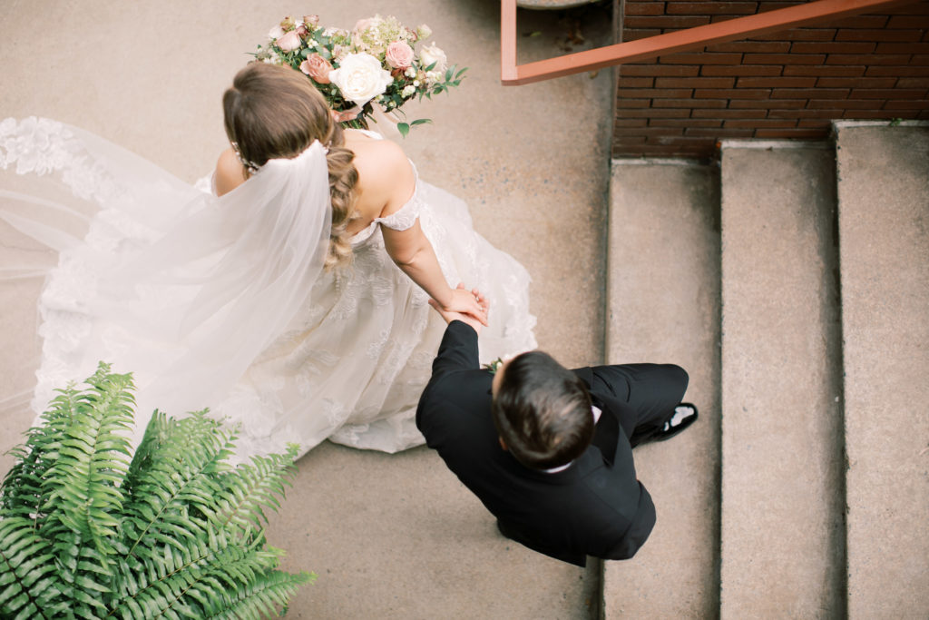 Bride and groom walking up stairs